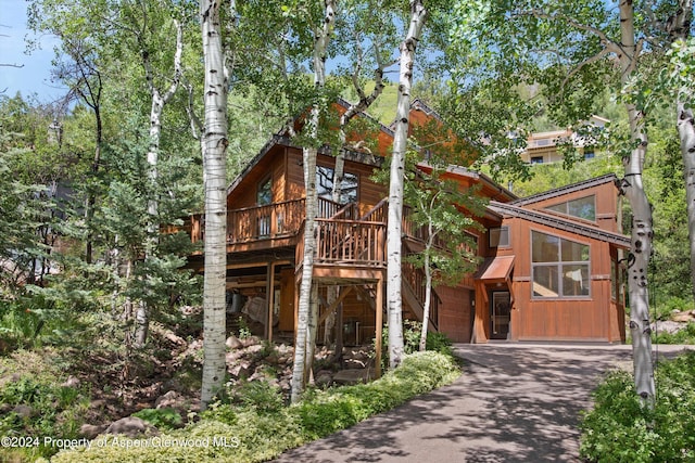 view of front of property with a garage and a wooden deck