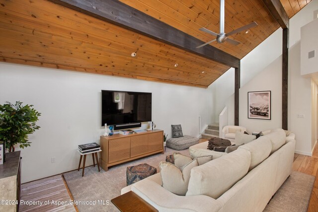 living room featuring beam ceiling, light hardwood / wood-style flooring, high vaulted ceiling, and wood ceiling