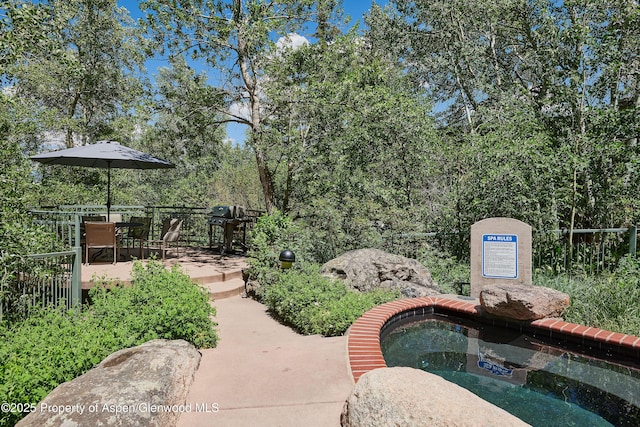 65 Campground Ln Unit 94, Snowmass Village, CO 81615 - view of community featuring a jacuzzi, outdoor dining area, and a patio area
