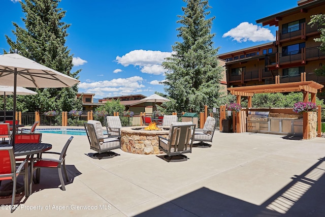 65 Campground Ln Unit 94, Snowmass Village, CO 81615 - view of patio / terrace featuring a fire pit and exterior kitchen