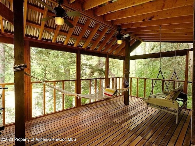 unfurnished sunroom featuring ceiling fan and lofted ceiling