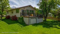8984 County Road 300, Parachute, CO 81635 - back of property featuring a yard and a wooden deck