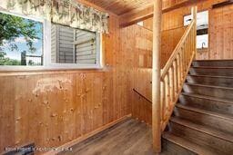 8984 County Road 300, Parachute, CO 81635 - staircase with wood walls and wood finished floors