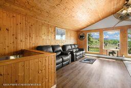 8984 County Road 300, Parachute, CO 81635 - living room with wood finished floors, wooden ceiling, vaulted ceiling, and wood walls