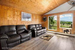 8984 County Road 300, Parachute, CO 81635 - living room with wood ceiling, plenty of natural light, wood finished floors, and vaulted ceiling