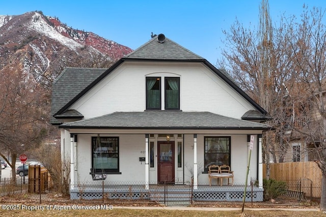 view of front of home with a mountain view and covered porch