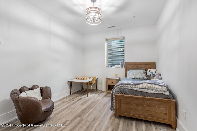577 Fox Run Dr, Carbondale, CO 81623 - bedroom with light wood-style floors and a chandelier