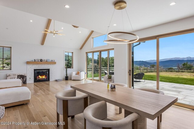 577 Fox Run Dr, Carbondale, CO 81623 - dining space with a mountain view, a chandelier, light wood-style floors, recessed lighting, and a tiled fireplace