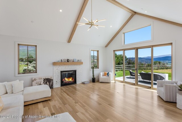 577 Fox Run Dr, Carbondale, CO 81623 - living area with a mountain view, high vaulted ceiling, a tile fireplace, beam ceiling, and wood finished floors