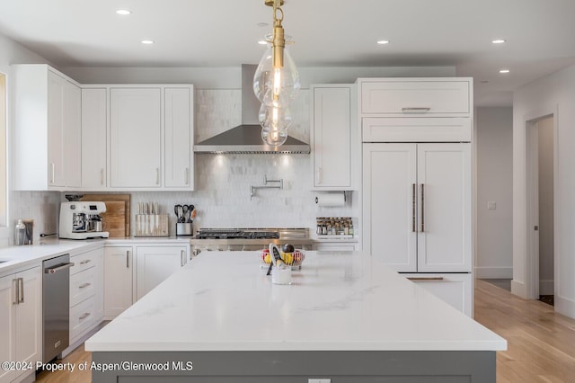 577 Fox Run Dr, Carbondale, CO 81623 - kitchen featuring paneled built in fridge, wall chimney range hood, stainless steel dishwasher, backsplash, and recessed lighting