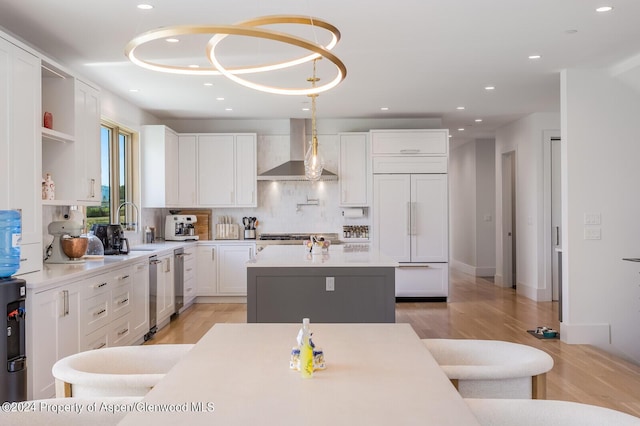 577 Fox Run Dr, Carbondale, CO 81623 - kitchen with wall chimney exhaust hood, paneled built in refrigerator, a center island, white cabinets, and open shelves