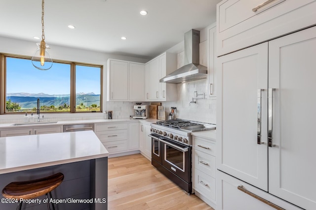 577 Fox Run Dr, Carbondale, CO 81623 - kitchen with stainless steel appliances, wall chimney exhaust hood, light countertops, recessed lighting, and backsplash