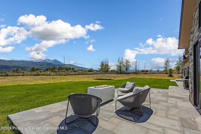 577 Fox Run Dr, Carbondale, CO 81623 - view of patio featuring a mountain view, a fire pit, a view of rural / pastoral area, and a trampoline