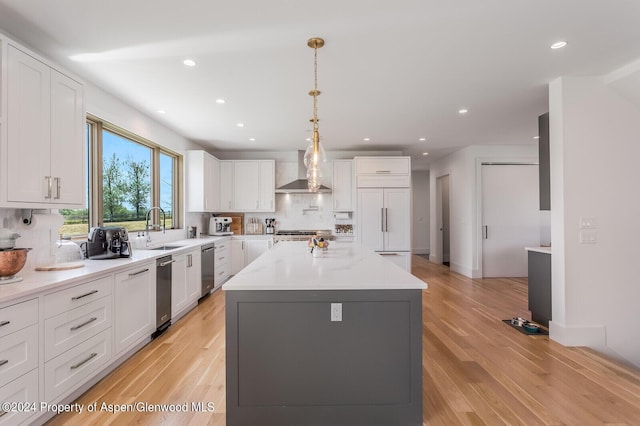 577 Fox Run Dr, Carbondale, CO 81623 - kitchen featuring tasteful backsplash, wall chimney exhaust hood, light wood-type flooring, recessed lighting, and white cabinetry