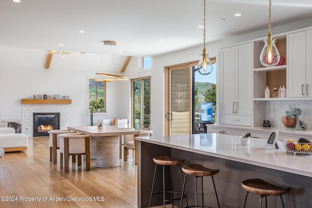 577 Fox Run Dr, Carbondale, CO 81623 - kitchen with a breakfast bar, open shelves, light wood-style floors, light countertops, and recessed lighting