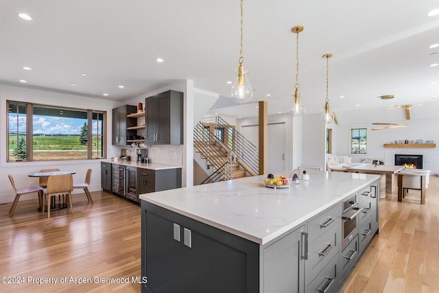 577 Fox Run Dr, Carbondale, CO 81623 - kitchen featuring gray cabinets, open shelves, plenty of natural light, light wood-style flooring, and recessed lighting