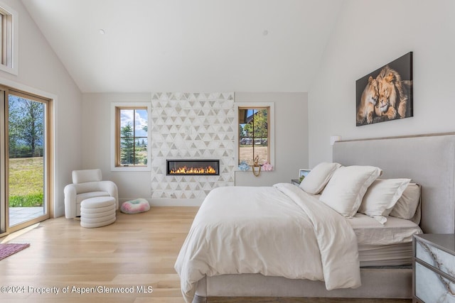 577 Fox Run Dr, Carbondale, CO 81623 - bedroom featuring wood finished floors, access to outside, a tile fireplace, and high vaulted ceiling
