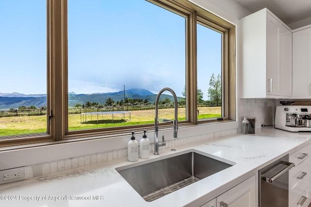 577 Fox Run Dr, Carbondale, CO 81623 - kitchen featuring a mountain view, dishwasher, white cabinets, and light stone countertops