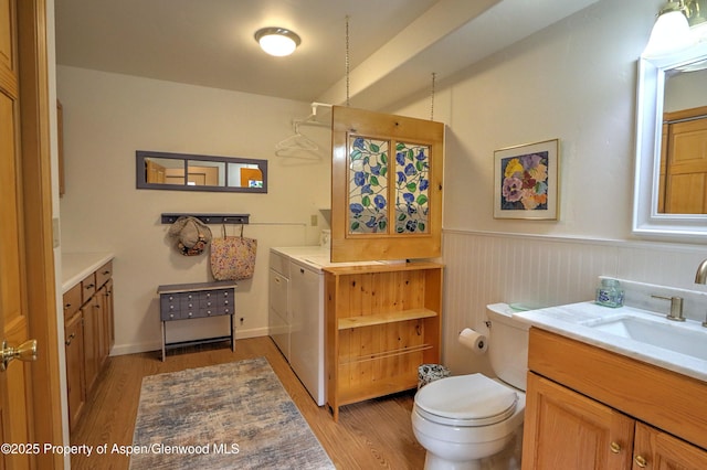 48 Creekside Ct, Glenwood Springs, CO 81601 - bathroom with wood finished floors, wainscoting, vanity, and toilet