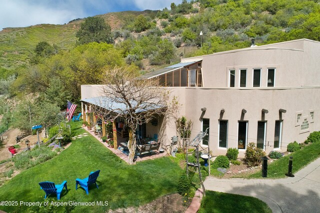 48 Creekside Ct, Glenwood Springs, CO 81601 - back of house featuring stucco siding and a yard