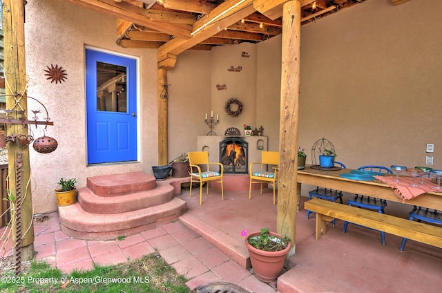 48 Creekside Ct, Glenwood Springs, CO 81601 - entrance to property with stucco siding, a patio, and outdoor dining area