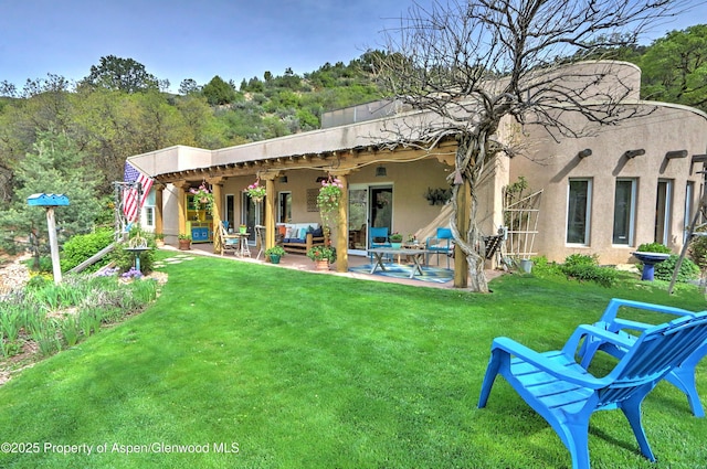48 Creekside Ct, Glenwood Springs, CO 81601 - rear view of property featuring outdoor lounge area, a lawn, a patio, stucco siding, and ceiling fan