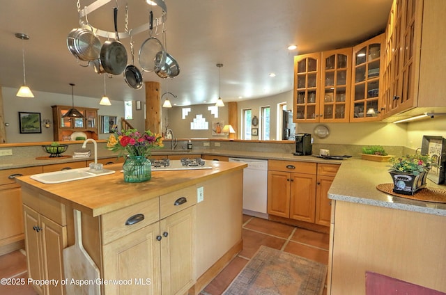 48 Creekside Ct, Glenwood Springs, CO 81601 - kitchen with white dishwasher, a sink, wooden counters, a peninsula, and a center island