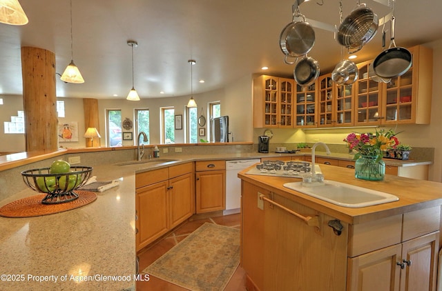 48 Creekside Ct, Glenwood Springs, CO 81601 - kitchen featuring a sink, white dishwasher, recessed lighting, glass insert cabinets, and pendant lighting