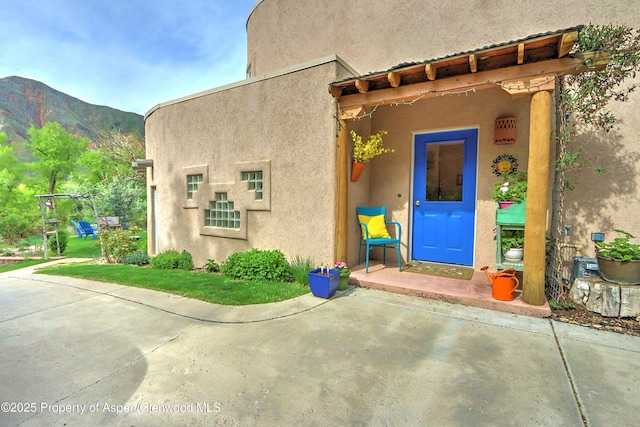 48 Creekside Ct, Glenwood Springs, CO 81601 - view of exterior entry with stucco siding and a mountain view