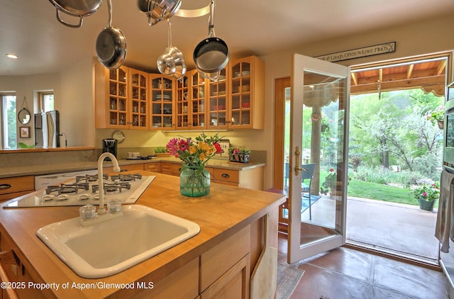 48 Creekside Ct, Glenwood Springs, CO 81601 - kitchen featuring a sink, glass insert cabinets, white gas cooktop, butcher block countertops, and a center island