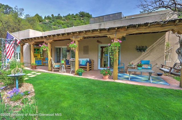 48 Creekside Ct, Glenwood Springs, CO 81601 - back of house featuring outdoor lounge area, a patio area, a yard, and stucco siding
