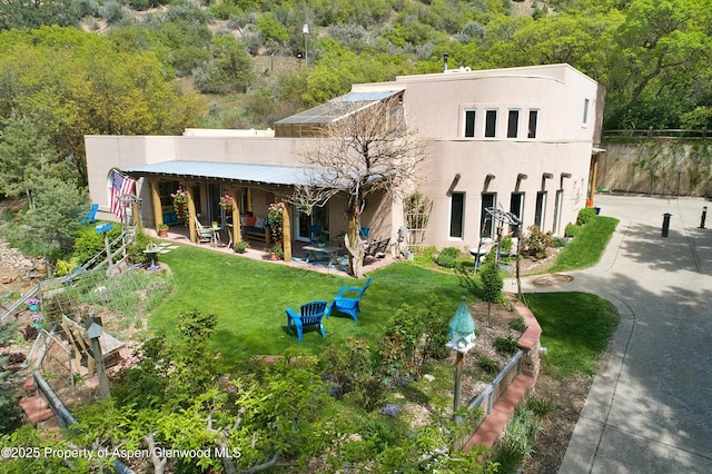 48 Creekside Ct, Glenwood Springs, CO 81601 - back of house with stucco siding, a patio, and a wooded view