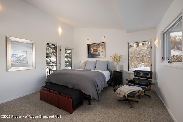 carpeted bedroom with lofted ceiling, multiple windows, and baseboards