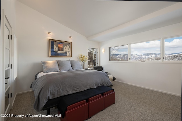 carpeted bedroom featuring lofted ceiling and baseboards