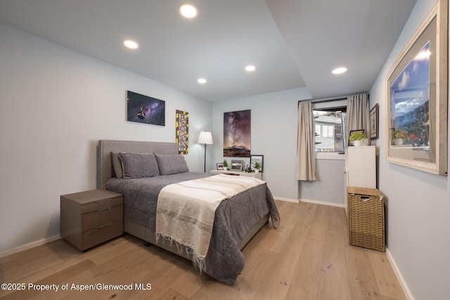 bedroom with baseboards, recessed lighting, and light wood-style floors