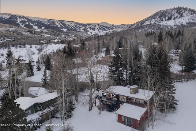 snowy aerial view featuring a mountain view