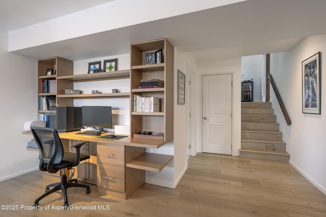 office space with light wood-style flooring and baseboards