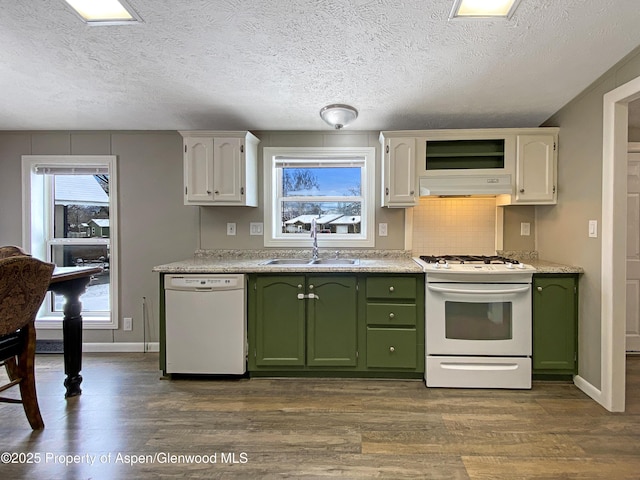 kitchen with white appliances, white cabinets, green cabinets, sink, and a healthy amount of sunlight