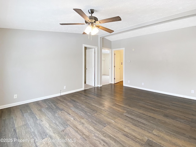 empty room with a textured ceiling, ceiling fan, and dark wood-type flooring