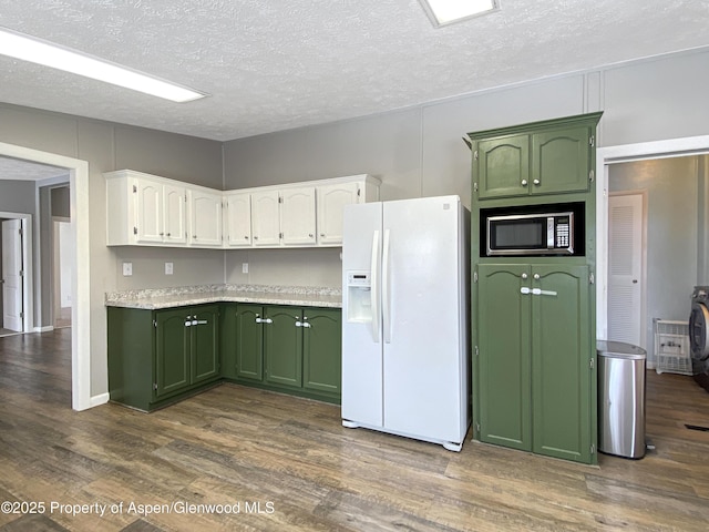 kitchen featuring dark hardwood / wood-style flooring, a textured ceiling, white fridge with ice dispenser, and green cabinets