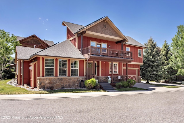 249 Whitehorse Dr, New Castle, CO 81647 - view of front of property with a balcony, roof with shingles, board and batten siding, stone siding, and an attached garage