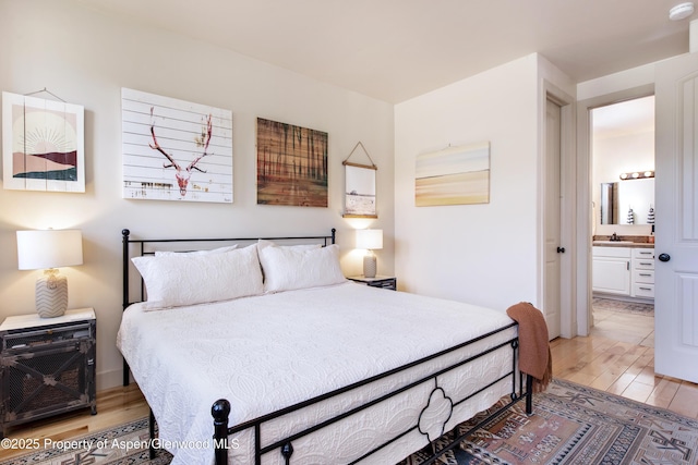 249 Whitehorse Dr, New Castle, CO 81647 - bedroom featuring light wood-type flooring, a sink, and ensuite bath
