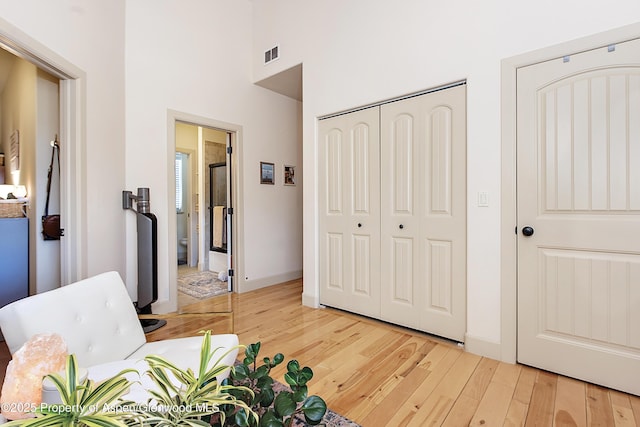 249 Whitehorse Dr, New Castle, CO 81647 - living area featuring light wood-style flooring, a high ceiling, and baseboards