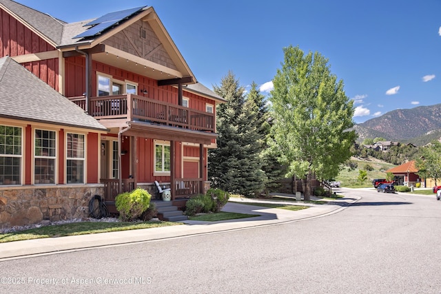 249 Whitehorse Dr, New Castle, CO 81647 - view of front facade featuring board and batten siding, roof with shingles, a balcony, and solar panels