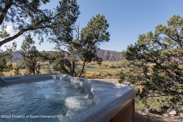 view of yard featuring a mountain view and a hot tub