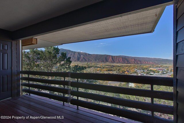 wooden deck featuring a mountain view