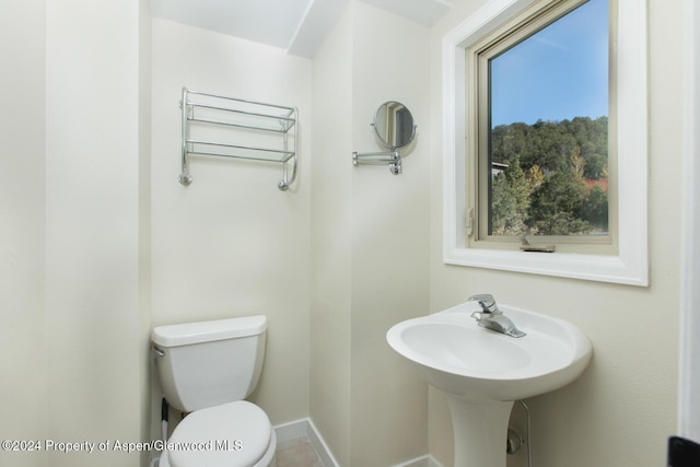 bathroom featuring toilet and radiator heating unit