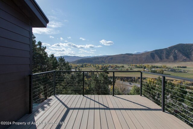 wooden terrace featuring a mountain view