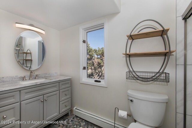 bathroom featuring vanity, toilet, and a baseboard radiator