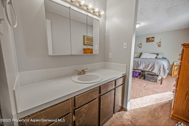 bathroom featuring a textured ceiling and vanity